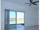 Bright living room features sliding glass doors with view of the lake at 2411 Paravane Way, Wesley Chapel, FL 33543