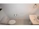 Small powder room features white fixtures and a modern, minimalist design at 2411 Paravane Way, Wesley Chapel, FL 33543