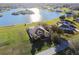 Aerial view of lakefront estate featuring an in-ground pool and private beach at 24355 Hideout Trl, Land O Lakes, FL 34639