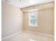 Comfortable bedroom featuring tile floors, a window, and neutral colored walls at 306 W Alva St, Tampa, FL 33603