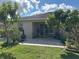 Spacious backyard with a covered patio, mature trees, and lush green grass, perfect for outdoor living at 3205 Majestic View Dr, Lutz, FL 33558
