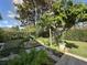 Lush backyard featuring a rock water feature and beautiful landscaping for outdoor enjoyment and relaxation at 3205 Majestic View Dr, Lutz, FL 33558