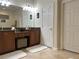 Bathroom with double vanity, tile floor, and a door to the water closet at 3205 Majestic View Dr, Lutz, FL 33558
