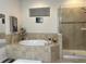 Bathroom with soaking tub and separate glass-enclosed shower at 3205 Majestic View Dr, Lutz, FL 33558