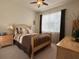 Cozy bedroom with a ceiling fan, a window with curtains, carpeted floors, and a warm, inviting color scheme at 3205 Majestic View Dr, Lutz, FL 33558