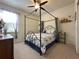 Bright bedroom with a four-poster bed, ceiling fan, and carpeted floors at 3205 Majestic View Dr, Lutz, FL 33558