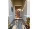 Warm and welcoming entryway featuring a stylish front door, stone walkway, and decorative plants at 3205 Majestic View Dr, Lutz, FL 33558