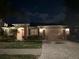 Inviting single-story home with professional landscaping, a brick driveway, and a two-car garage at 3205 Majestic View Dr, Lutz, FL 33558