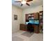 Inviting home office with a wooden desk, bookcase, dual monitors, ceiling fan, and comfortable workspace at 3205 Majestic View Dr, Lutz, FL 33558