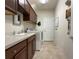 A functional laundry room with upper cabinets, a utility sink, and modern washer and dryer at 3205 Majestic View Dr, Lutz, FL 33558