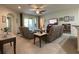 Spacious living room with neutral tones, ceiling fan, and sliding glass doors to outdoor space at 3205 Majestic View Dr, Lutz, FL 33558