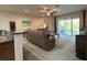 Bright living room with sliding glass doors to the patio and neutral decor at 3205 Majestic View Dr, Lutz, FL 33558