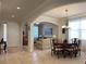Spacious living room flowing into the dining area, featuring arched doorways and neutral décor at 3205 Majestic View Dr, Lutz, FL 33558