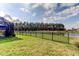 Enjoy the peaceful backyard with screened patio, lush green lawn and pond scenery at 34747 Telluride Ln, Zephyrhills, FL 33541