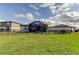 This home features a large fenced backyard with a screened lanai and ample room for outdoor activities at 34747 Telluride Ln, Zephyrhills, FL 33541