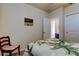 Bedroom with a full sized bed, chair, and bathroom access at 34747 Telluride Ln, Zephyrhills, FL 33541
