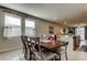 Dining area with wood table and chairs complemented by a neutral color scheme at 34747 Telluride Ln, Zephyrhills, FL 33541