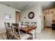 Dining room with a wooden table, seating for six, and access to entryway and kitchen at 34747 Telluride Ln, Zephyrhills, FL 33541