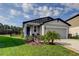 Charming single-story home features a manicured lawn and a two-car garage at 34747 Telluride Ln, Zephyrhills, FL 33541