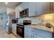 Well-appointed kitchen featuring stainless steel appliances and granite countertops at 34747 Telluride Ln, Zephyrhills, FL 33541