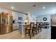 Modern kitchen with stainless steel appliances and an island with bar seating at 34747 Telluride Ln, Zephyrhills, FL 33541