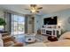 Open living room featuring comfortable seating, a ceiling fan, and sliding doors to the outdoor patio at 34747 Telluride Ln, Zephyrhills, FL 33541