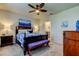 Comfortable main bedroom with a king bed, a ceiling fan, and an ensuite bathroom at 34747 Telluride Ln, Zephyrhills, FL 33541