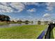 Picturesque view of the pond and surrounding landscape, creating a tranquil backyard setting at 34747 Telluride Ln, Zephyrhills, FL 33541