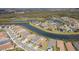 Expansive aerial shot of houses lining a waterway, showcasing community living and waterfront views at 4920 Sevilla Shores Dr, Wimauma, FL 33598