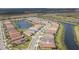 Stunning aerial view of a residential community featuring waterfront homes and serene ponds at 4920 Sevilla Shores Dr, Wimauma, FL 33598