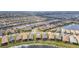 Expansive aerial view showcasing a Primary-planned community with numerous homes and water features at 4920 Sevilla Shores Dr, Wimauma, FL 33598