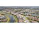 An aerial view of a community of single Gathering homes situated by ponds and canals at 4920 Sevilla Shores Dr, Wimauma, FL 33598