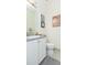 Elegant bathroom showcasing a vanity with granite countertop and classic movie poster at 4920 Sevilla Shores Dr, Wimauma, FL 33598