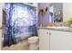 Bathroom showcasing a vanity with granite countertops and a shower with a decorative curtain at 4920 Sevilla Shores Dr, Wimauma, FL 33598