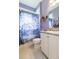 Bathroom featuring a vanity with granite counters, tiled floors, and a colorful shower curtain at 4920 Sevilla Shores Dr, Wimauma, FL 33598
