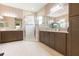 Spacious bathroom boasts dual sinks, a walk-in shower, and tile flooring at 4920 Sevilla Shores Dr, Wimauma, FL 33598