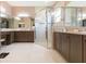 Bright bathroom featuring a glass shower, double vanity, and tile flooring at 4920 Sevilla Shores Dr, Wimauma, FL 33598