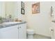 Stylish bathroom featuring a granite countertop and decorative Casablanca movie poster at 4920 Sevilla Shores Dr, Wimauma, FL 33598