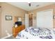 Comfortable bedroom with a double bed, wooden dresser, and a view of the closet at 4920 Sevilla Shores Dr, Wimauma, FL 33598