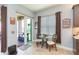 Cozy breakfast nook featuring a glass table, seating for two, and a view to an outdoor patio and landscaped yard at 4920 Sevilla Shores Dr, Wimauma, FL 33598