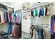 Walk-in closet featuring custom organization shelves and hanging rods for optimal storage at 4920 Sevilla Shores Dr, Wimauma, FL 33598