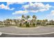 Beautiful clubhouse entrance with landscaped roundabout and well-maintained facade at 4920 Sevilla Shores Dr, Wimauma, FL 33598