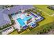 Aerial view of a community pool with seating areas, cabanas, and beautiful landscaping at 4920 Sevilla Shores Dr, Wimauma, FL 33598