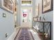 Bright entryway featuring tile flooring, a console table, and an overhead transom window at 4920 Sevilla Shores Dr, Wimauma, FL 33598
