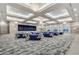 Spacious event space with elegant chandeliers, neutral walls and blue table linens at 4920 Sevilla Shores Dr, Wimauma, FL 33598