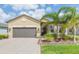 Charming one-story home with well-maintained landscaping and a brick driveway leading to the garage at 4920 Sevilla Shores Dr, Wimauma, FL 33598