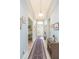 Bright foyer with a view of the front door, a long hallway, and decorative furniture at 4920 Sevilla Shores Dr, Wimauma, FL 33598