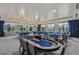 Upscale game room featuring poker and billiards tables, perfect for entertaining guests at 4920 Sevilla Shores Dr, Wimauma, FL 33598