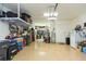 This is a wide angle view of a garage with a shiny floor, garage door, and lots of items stored at 4920 Sevilla Shores Dr, Wimauma, FL 33598