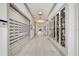 Well-lit hallway with mailboxes, display cases, and elegant tile flooring at 4920 Sevilla Shores Dr, Wimauma, FL 33598